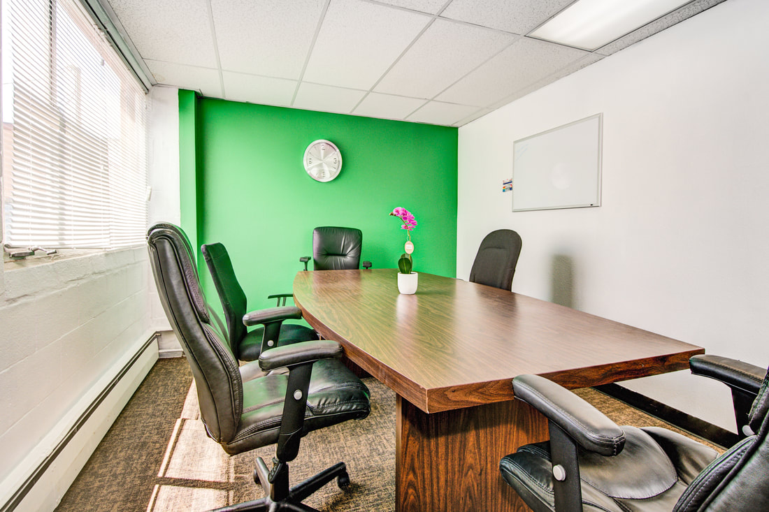 Photo of 12-person executive conference room with window and whiteboard