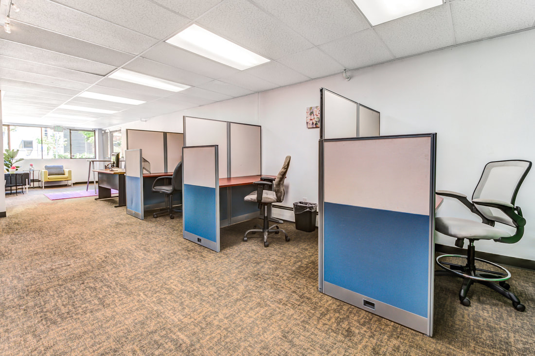 Photo of an open area with cubicles on the side